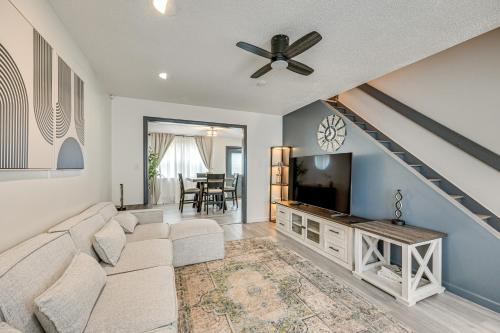 a living room with a couch and a flat screen tv at Townhome 1 Mi to Colt Park and Industrial District! in Hartford