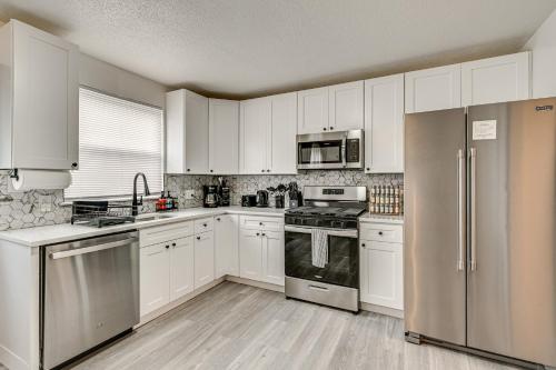 a kitchen with white cabinets and stainless steel appliances at Townhome 1 Mi to Colt Park and Industrial District! in Hartford