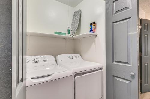 a small white laundry room with a washer and dryer at Townhome 1 Mi to Colt Park and Industrial District! in Hartford