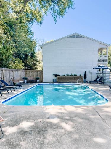 a swimming pool with a bench in a yard at Downtown OS 2bed 1 bath with pool and close to the beach in Ocean Springs