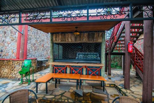a painting of a stage with a table and chairs at Thitu Log House in Nakuru