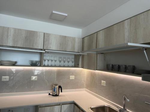 a kitchen with a sink and a counter top at Crystal al mar in Puerto Madryn