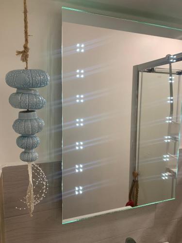 a mirror in a bathroom with a stack of rocks at Casa Mareo in Capraia