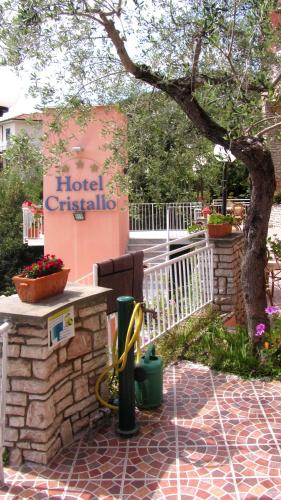 a hotel originals sign and flowers in front of a building at Hotel Cristallo in Lerici