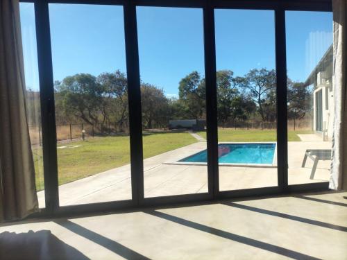 a window view of a pool from a house at Sango on 9 in Naboomspruit