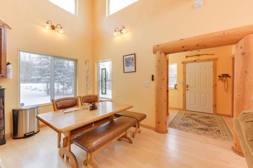 a dining room with a wooden table and chairs at 5 Mi to Kasilof River Forest-View Retreat with Deck in Kasilof