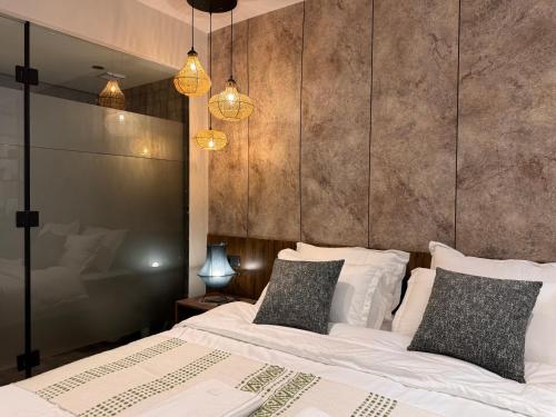 a bedroom with two beds with white sheets and pillows at Penthouse-fes in Fès