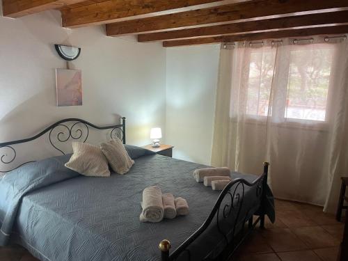 a bedroom with a bed with towels on it at La Casa degli Enzi in Portoscuso