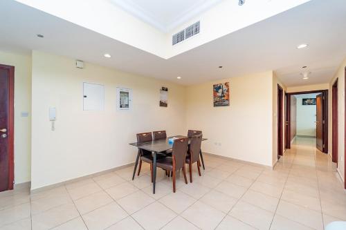 a dining room with a table and chairs at Beachfront holiday homes with beach,sauna,jacuzzi,cafe,restaurants and more in Ajman