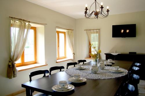 a dining room with a wooden table and chairs at Pūjalgi in Ēdole