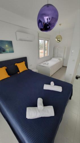 a bedroom with a large bed with two towels on it at Aegean dream house in Ofrínion