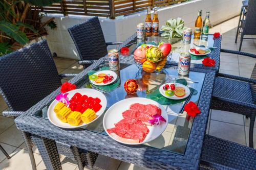 a blue table with plates of food on it at ビーチまで車で2分 BBQセットあり 車2台駐車可能 バリアフリーok Terrace Garden Okinawa in Yamada