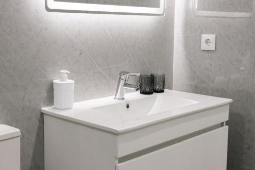 a bathroom with a white sink and a toilet at Casa da Tininha in Couto