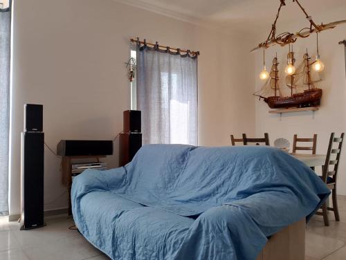 a bedroom with a bed with a blue blanket at Myriamare in Manfredonia