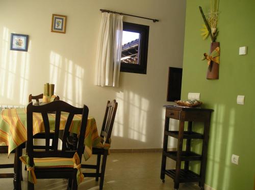 a room with a table and a chair and a window at Apartamentos Rurales Obaya in Villaviciosa