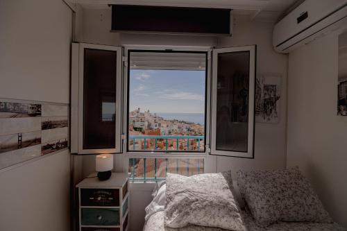 a bedroom with a bed and a window with a view at Casa Melina in Cala del Moral