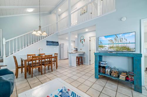 a living room with a table and a dining room at Paradise Duplex A in Gulf Shores