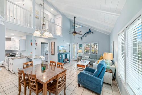 a kitchen and living room with a table and a couch at Paradise Duplex A in Gulf Shores