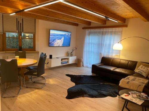 a living room with a couch and a table at Inntal Alpin Apartments - Niedere Munde in Telfs