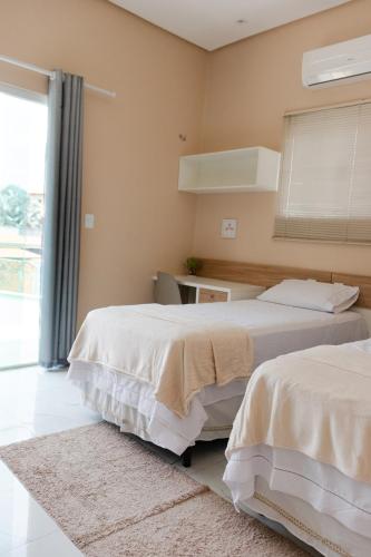 Postel nebo postele na pokoji v ubytování Casa juçara lençóis