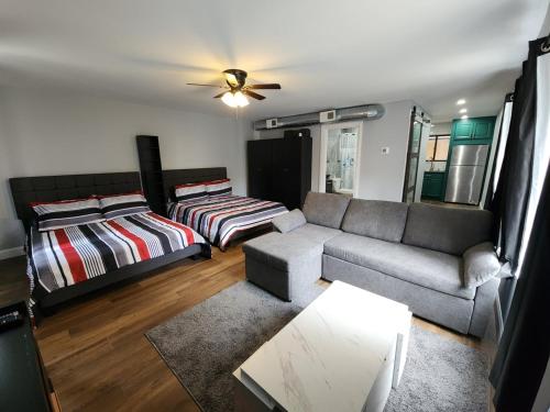 a living room with a couch and a bed at The Lucky Nook-Comfortable Studio, Close to All in Atlantic City
