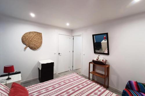 a bedroom with a bed and a tv on a wall at Quinta das Lameiras in Sao Pedro de Tomar
