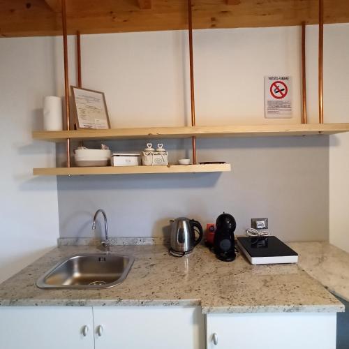 a kitchen with a sink and a counter top with a sink at Agriturismo La tana della volpe in Alberese