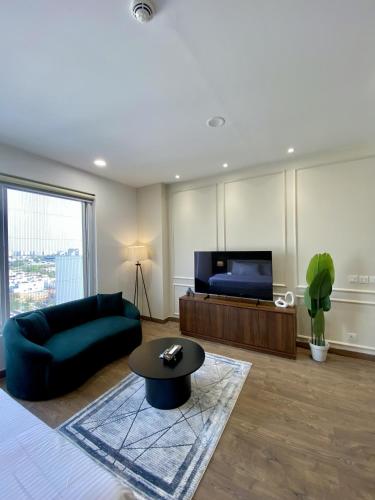 a living room with a couch and a tv at PENTASQUARE Apartments by SUPERHOST STAYS in Lahore