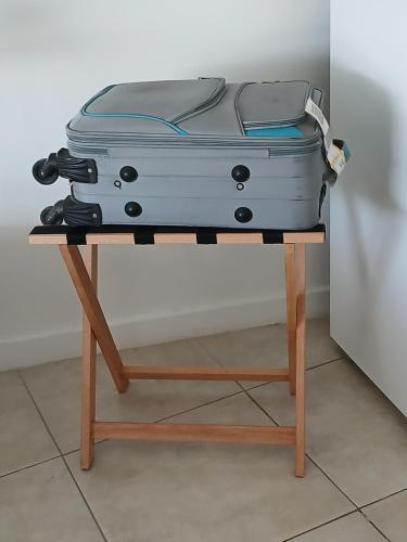 a suitcase sitting on a stand on a table at Departamento Poeta in Salta
