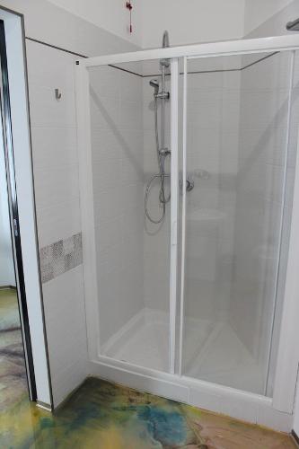 a shower with a glass door in a bathroom at Follow Me B&B in San Salvo