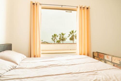 Ένα ή περισσότερα κρεβάτια σε δωμάτιο στο Beach House Rosarito