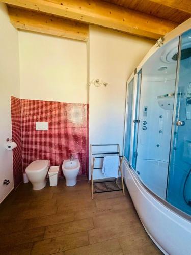 a bathroom with a toilet and a sink and a shower at Holiday House Valpiè in Avola