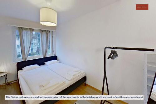 a bedroom with a bed and a lamp in it at Convenient 3BR Stay with Easy Transport in Zürich