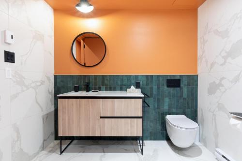 a bathroom with a sink and a toilet at Les Lofts Dorchester - Par Les Lofts Vieux-Québec in Quebec City