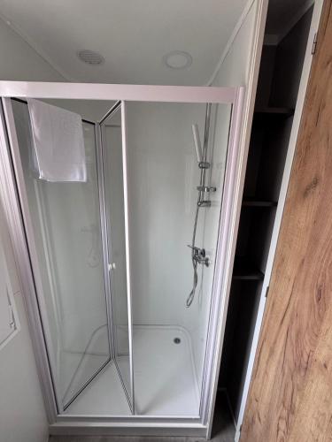 a shower stall with a glass door in a room at Ventura mobile home in Biograd na Moru