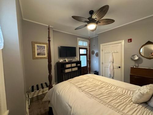 a bedroom with a bed and a ceiling fan at Susquehanna Manor Inn in Marietta