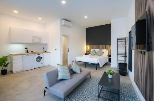 a large living room with a bed and a couch at Nomad Malaga - Airport II in Málaga