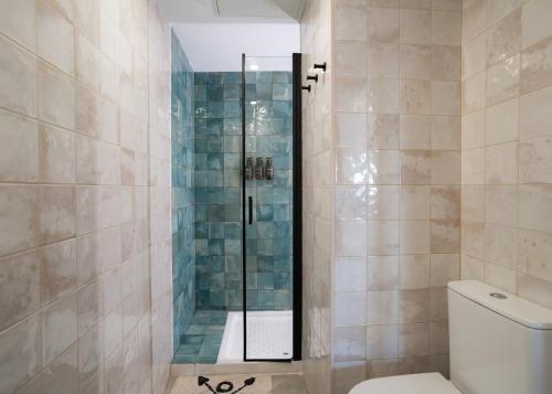 a bathroom with a glass shower with a toilet at Nomad Malaga - Airport II in Málaga