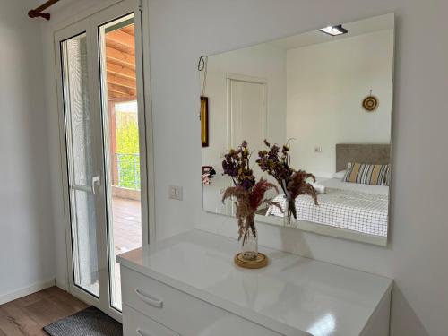 a bathroom with a mirror and a white dresser at Raffaello's Villa in Vlorë