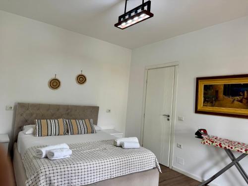 a bedroom with a bed with two towels on it at Raffaello's Villa in Vlorë