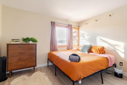 a bedroom with a bed and a dresser and a window at 1 BD Boulder Getaway - Pets Allowed with Full Amenities in Boulder