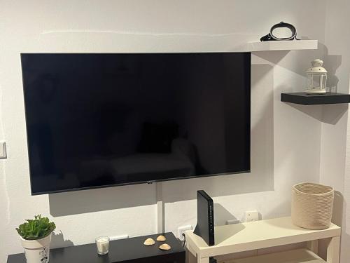 a large flat screen tv hanging on a wall at Casa Chacho, Punta Mujeres in Punta de Mujeres