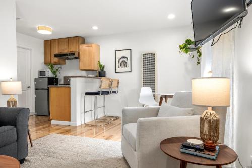 a living room with a couch and a table at Swell House Santa Cruz in Santa Cruz