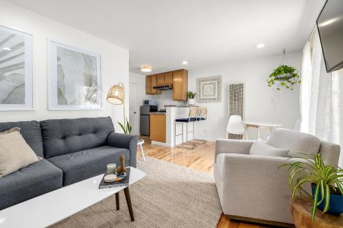 a living room with a couch and a table at Swell House Santa Cruz in Santa Cruz