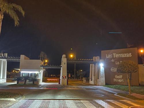 a parking lot at night with a bridge in the background at Atico Miso in Torre-Pacheco