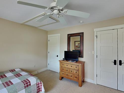 a bedroom with a ceiling fan and a television on a dresser at Some Kind of Wonderful in Oakland