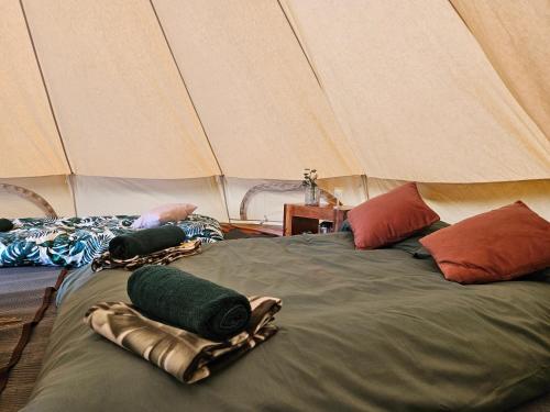 a bedroom with two beds in a tent at Readers Field Glamping in Great Sampford