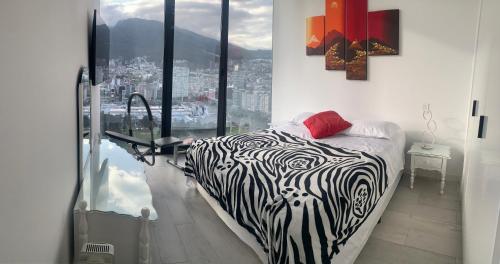 a zebra print bed in a room with a window at B&B KELLY Ecuador in Quito