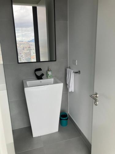 a bathroom with a white sink and a mirror at B&B KELLY Ecuador in Quito