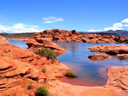 a river in the middle of a desert with rocks at Sonoro Sands in Hurricane
